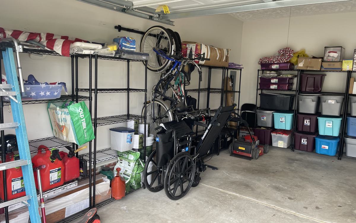 A cleared garage after a pickup, shelving and floor usable again