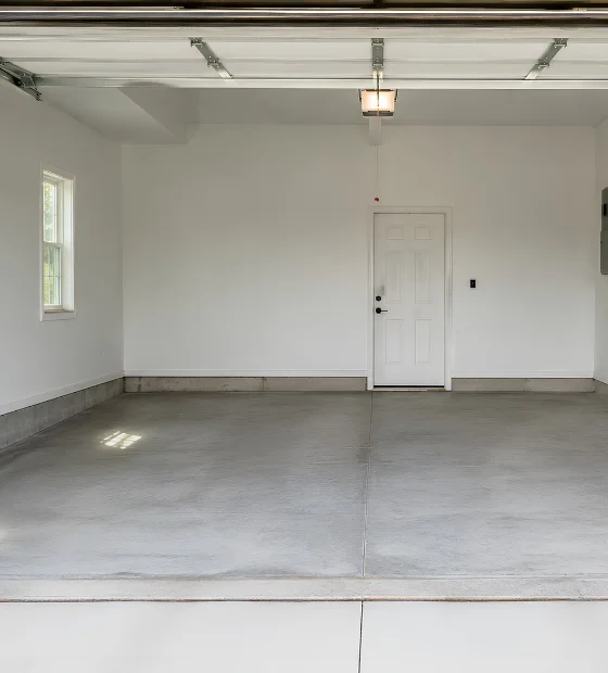 Garage Cleanouts: an empty two-car garage with a swept concrete floor