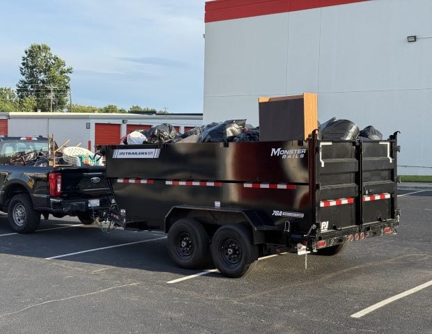 Haulchemy truck and full dump trailer loaded with items removed during a storage unit cleanout in South Charlotte, NC.
