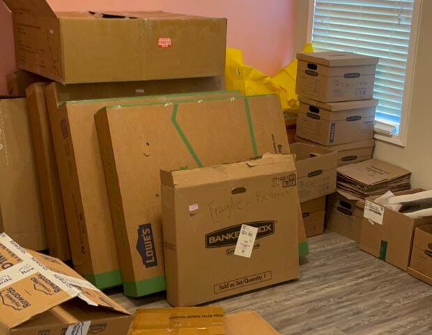 Cardboard moving boxes and packing materials stacked inside a room before Haulchemy's removal job in Indian Trail, NC.